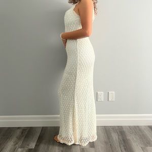 White pearl dress with blue fabric underneath.